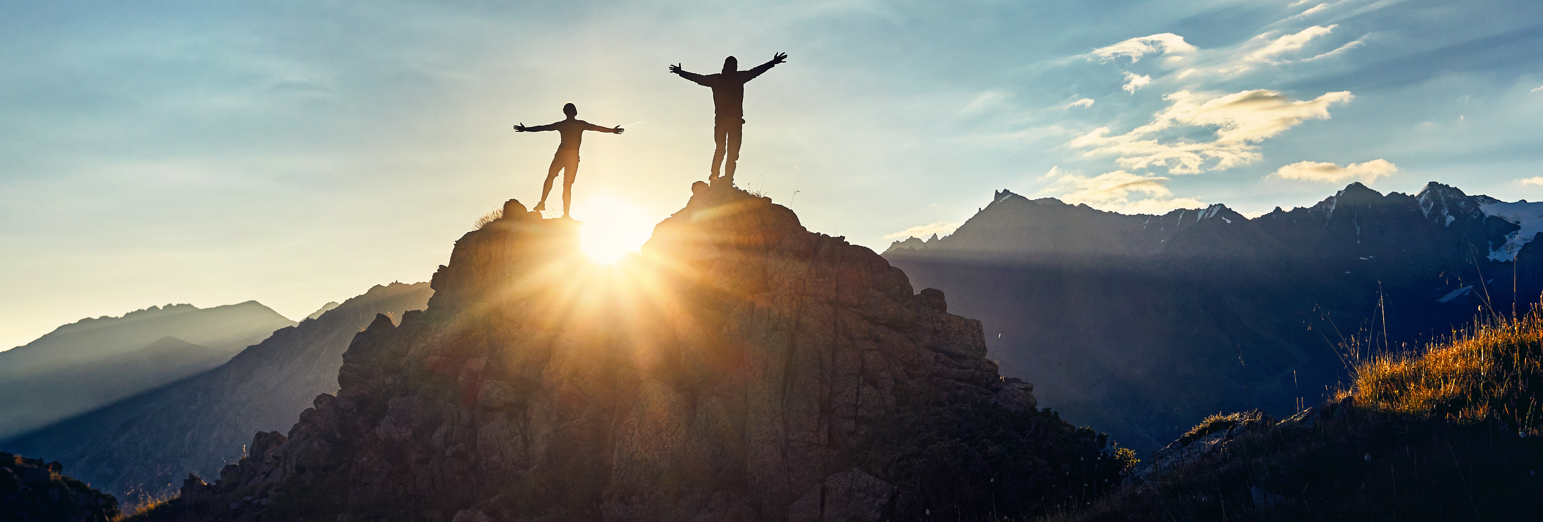 two mans standing on mountain.