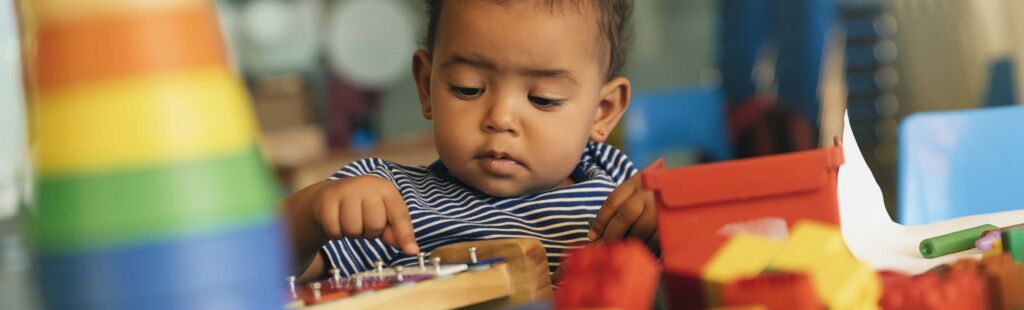 toddler plays with xylophone in a preschool
